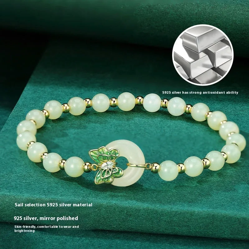 Cyan Hetian Jade bracelet with butterfly design and sterling silver accents, 6mm bead size