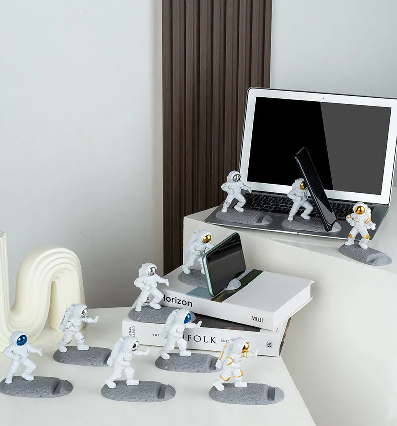 Astronaut decoration spaceman plastic mobile phone holder in blue, gold, and silver colours for lazy binge-watching