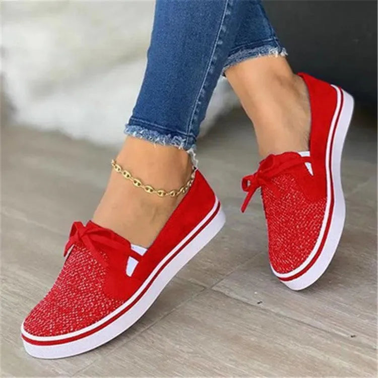 Women's low top flat shoes with cloth upper and shallow mouth cut, shown in white, red, blue, and black