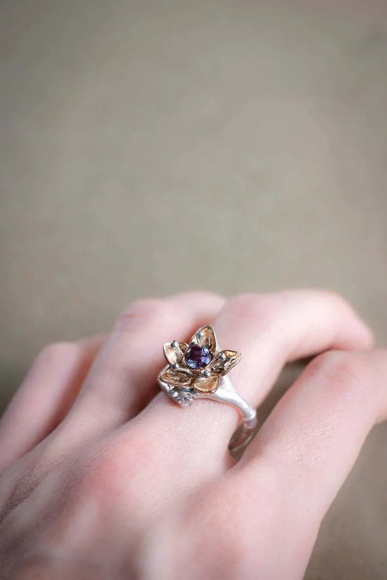 Two-tone silver alloy women's ring with a simple geometric and floral design on a white background.