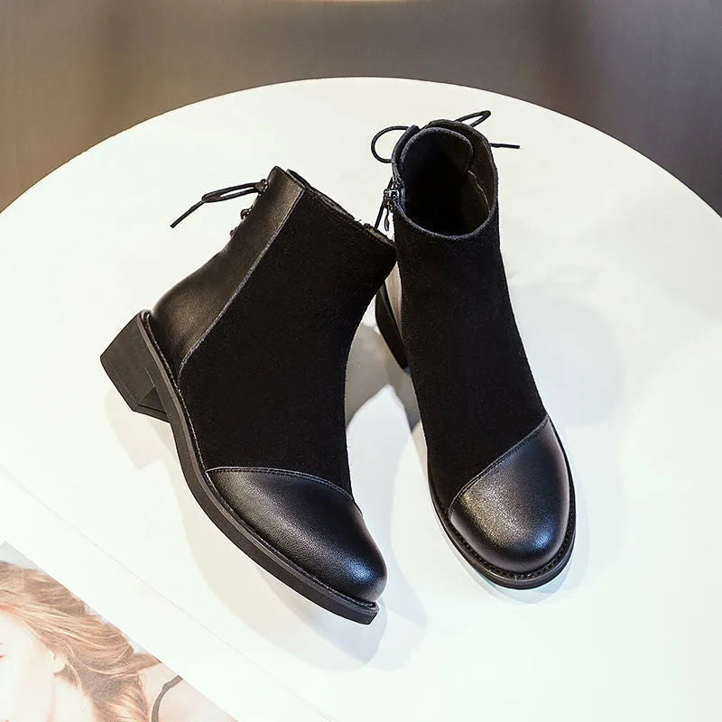 Black women's knee-high Martin boots with a side zip and decorative bow.