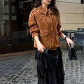 Bright brown women's suede-style polyester coat with regular sleeves on a hanger.