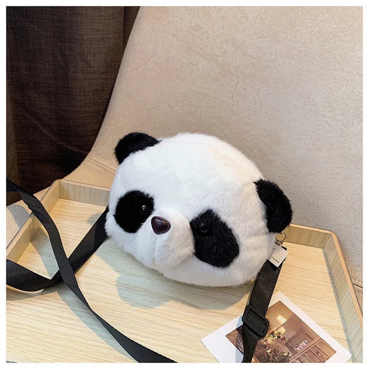 Soft plush panda head design crossbody bag in cylindrical shape on a white background.