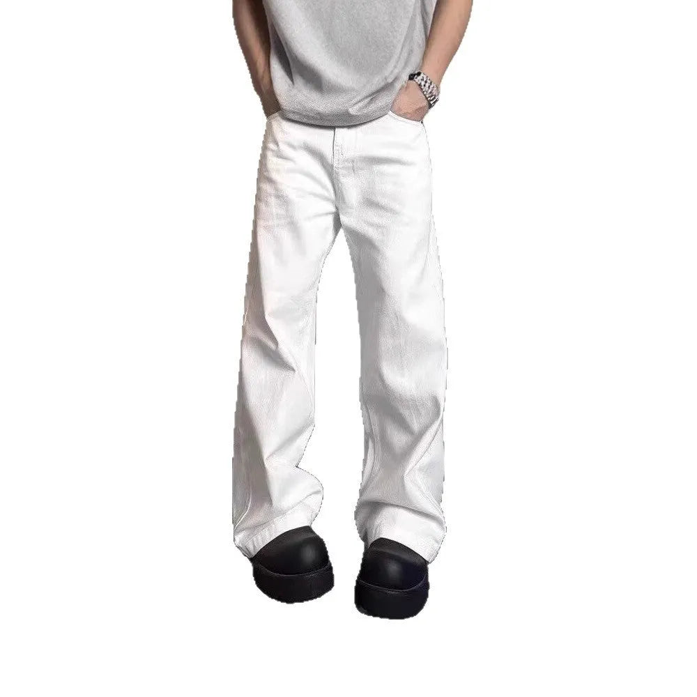 A pair of men's loose-fit white straight-leg cotton jeans on a plain background.