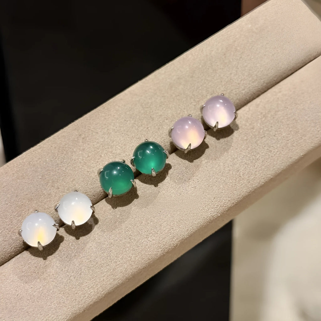 Round egg surface chalcedony stud earrings with four claw settings in emerald green, milk white, or pink purple.