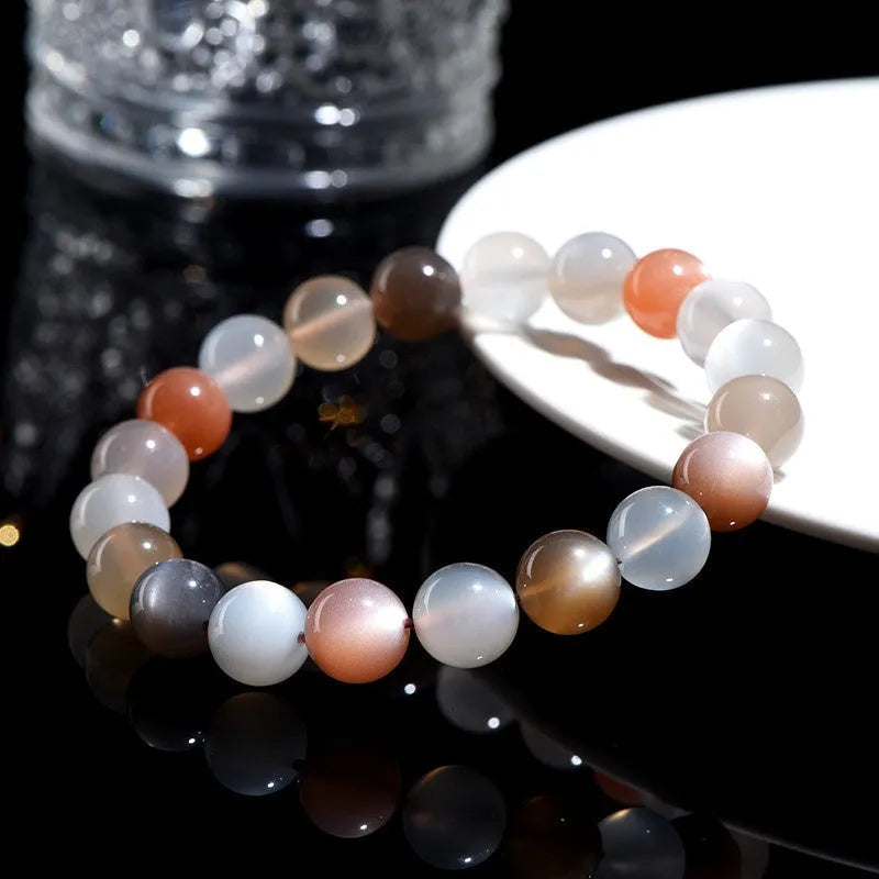 Natural colourful moonlight moonstone bracelet with 8mm single circle beads on a wrist.