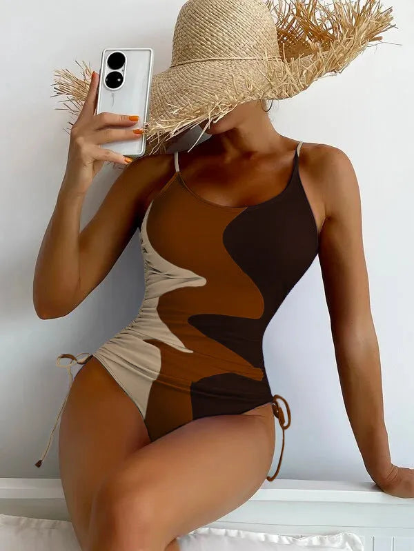 Women's blue sleeveless backless one-piece swimsuit with a striped print on a mannequin.