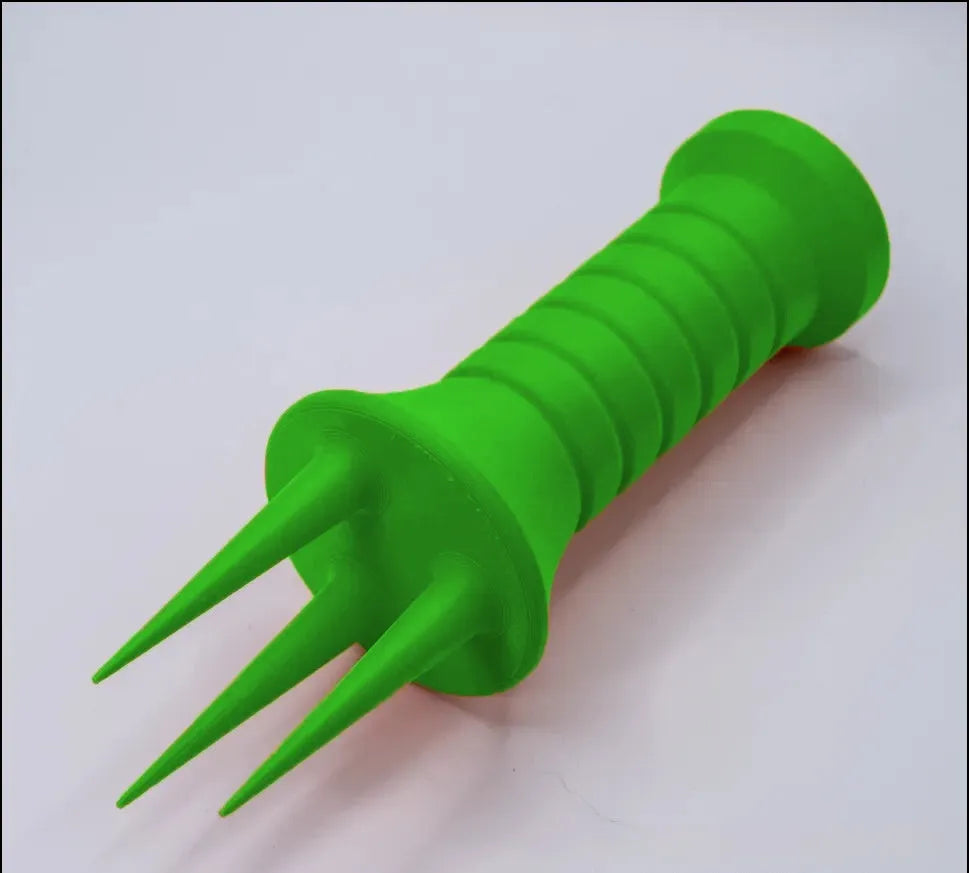 Home gardening soil aerator plastic hand tool in orange, 3.3cm x 10cm size, on soil