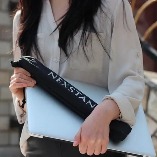 Sagacious black foldable laptop stand made of enhanced nylon, shown open and next to its portable carry bag.