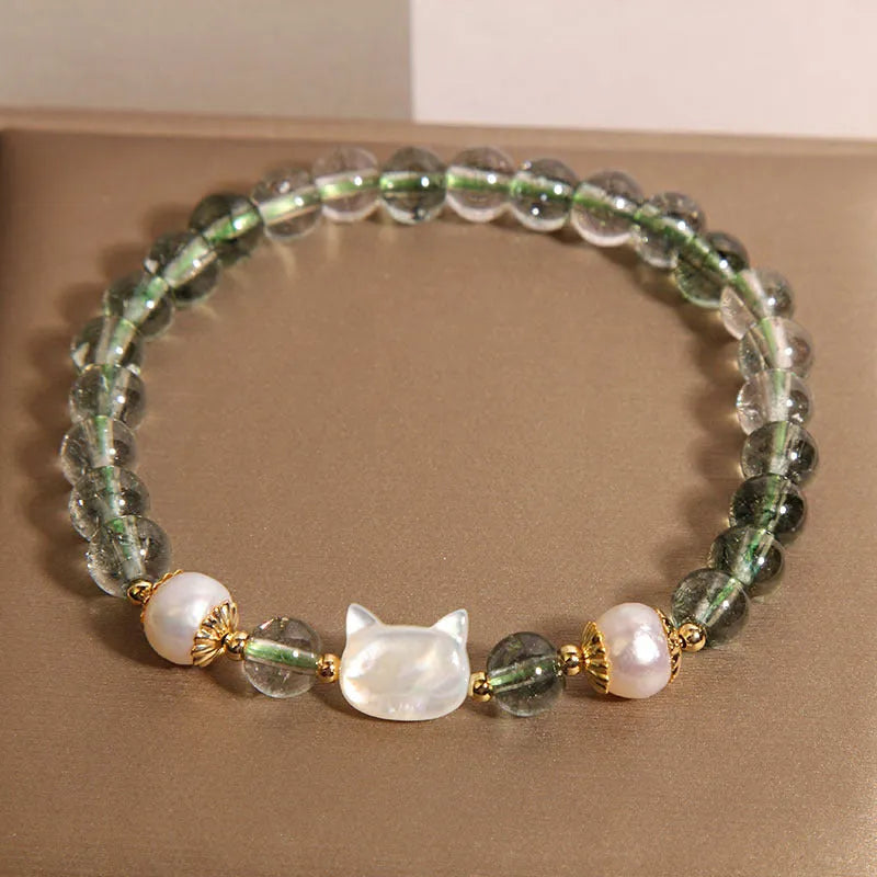 Green phantom quartz bracelet with shell kitten charm on wrist