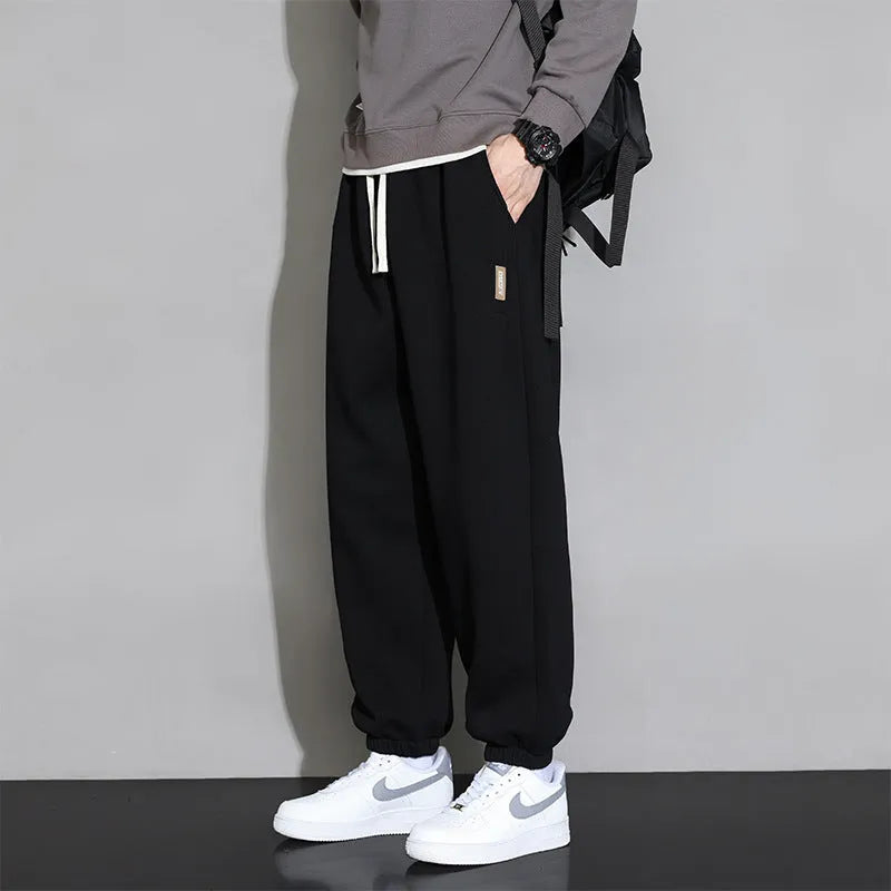 Men's loose grey sports trousers with drawstring waist in cotton-polyester blend