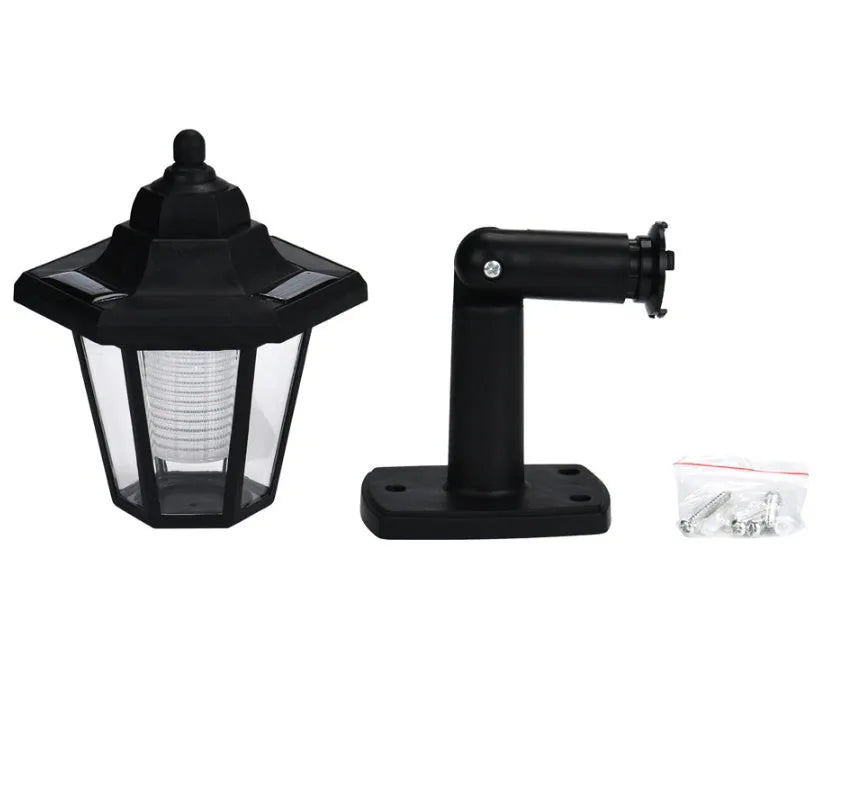 Black hexagonal solar-powered wall lamp for outdoor garden use.