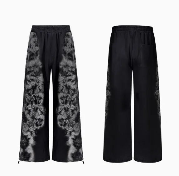 Three-piece streetwear clothing set showing printed hoodie, loose trousers, and shorts with collage stitching detail.