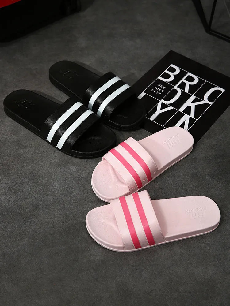 Striped PVC bath slippers for men and women in white with injection-moulded sole, side view