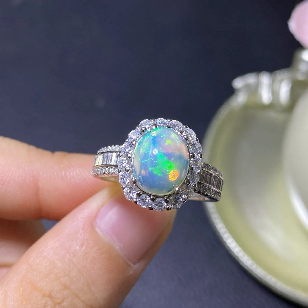 Handmade adjustable silver ring with a natural opal, shown in rose gold plating.