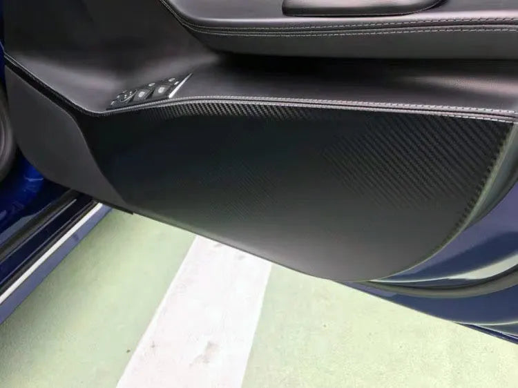 Four pre-cut carbon fibre protective films for Tesla Model S interior door control layouts.