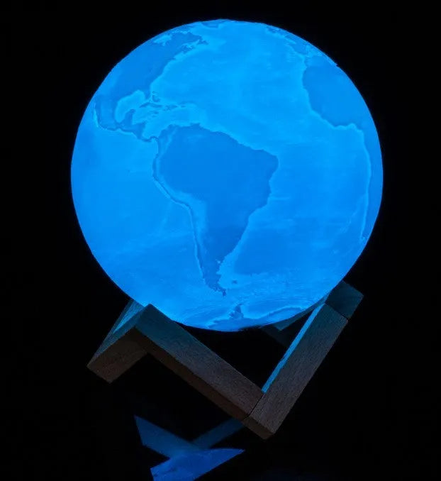 3D printed white moon lamp with detailed craters on a wooden holder, showing touch ring at base.