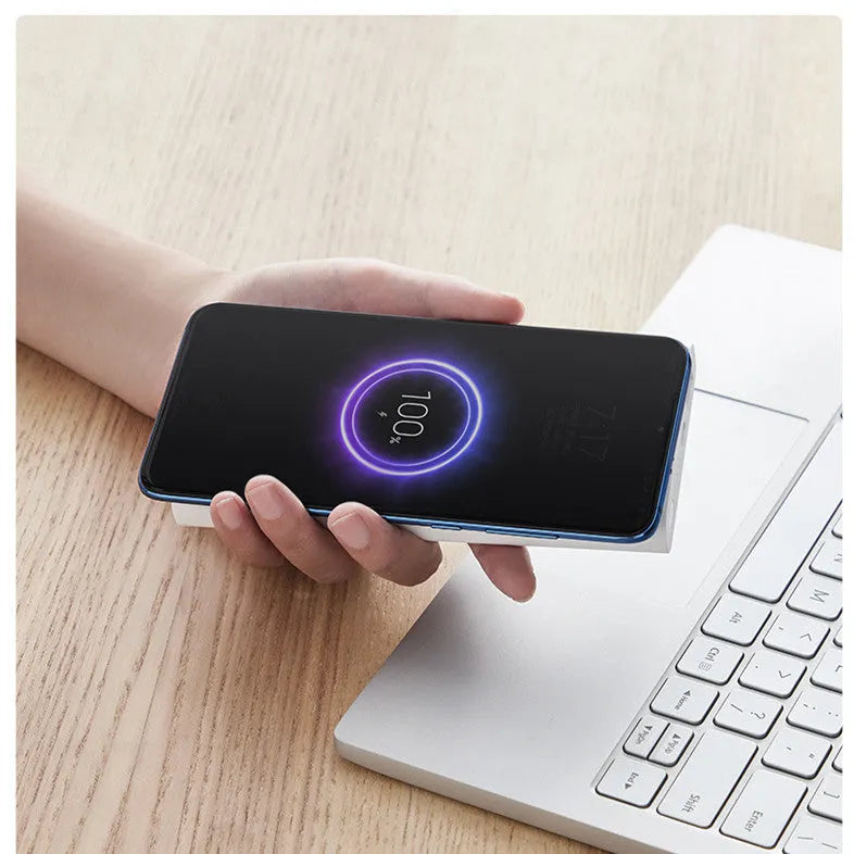 Black and white 10000mAh power bank with wireless charging and USB Type C port.