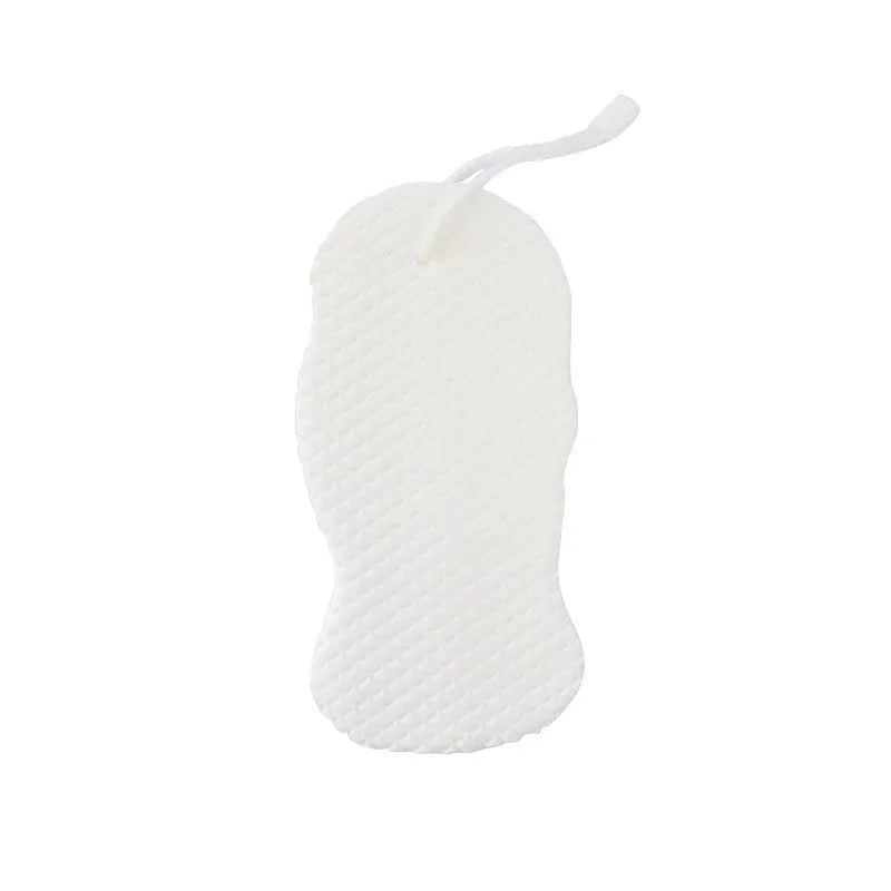 White 3D fish scale pattern bath sponge with hang loop on a bathroom background.