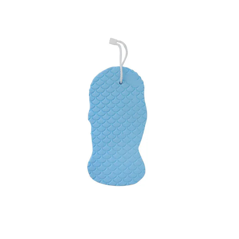 White 3D fish scale pattern bath sponge with hang loop on a bathroom background.