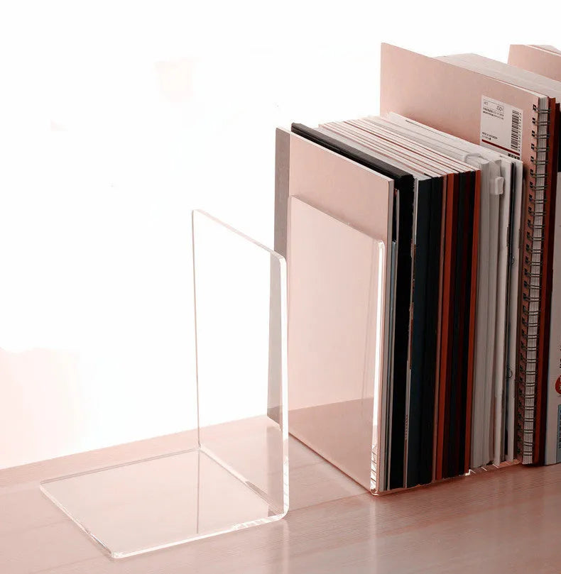 Transparent acrylic bookshelf display rack on a desk holding two books.