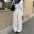 White striped wide-leg trousers with zipper detailing on loose casual silhouette
