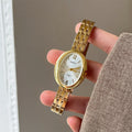 Oval alloy ladies watch with gold strap and choice of white gold or red dial face stainless steel back