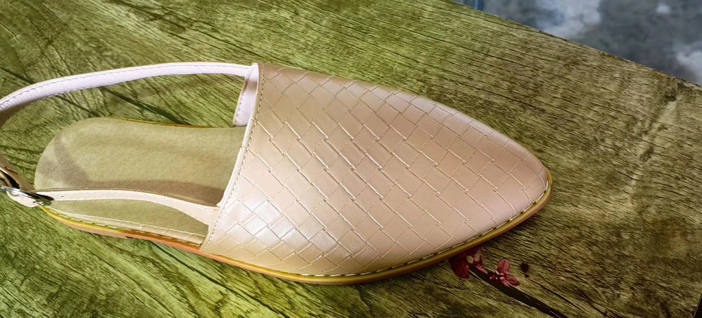 A pair of pointed toe, baotou flat sandals with a central buckle fastening, shown in a selection of colours.