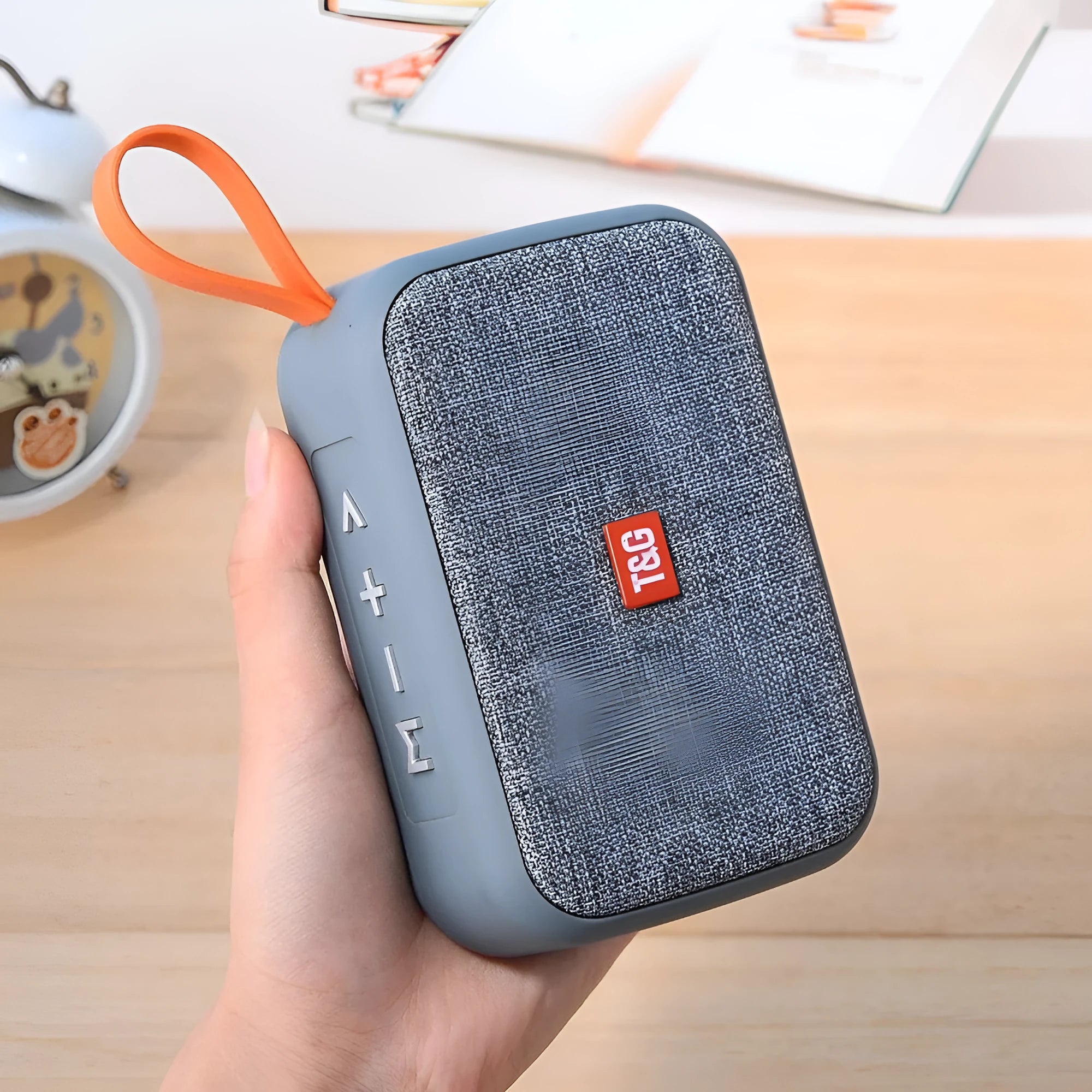 Compact sports Bluetooth speaker in black with radio, USB port, and key controls