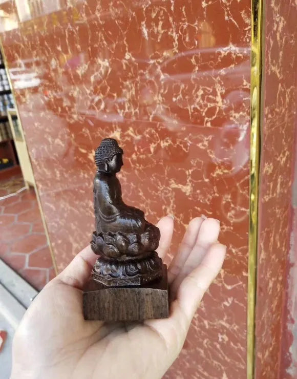 Hand-carved Sakyamuni Buddha statue in natural black wood, 30cm tall, for home or office display