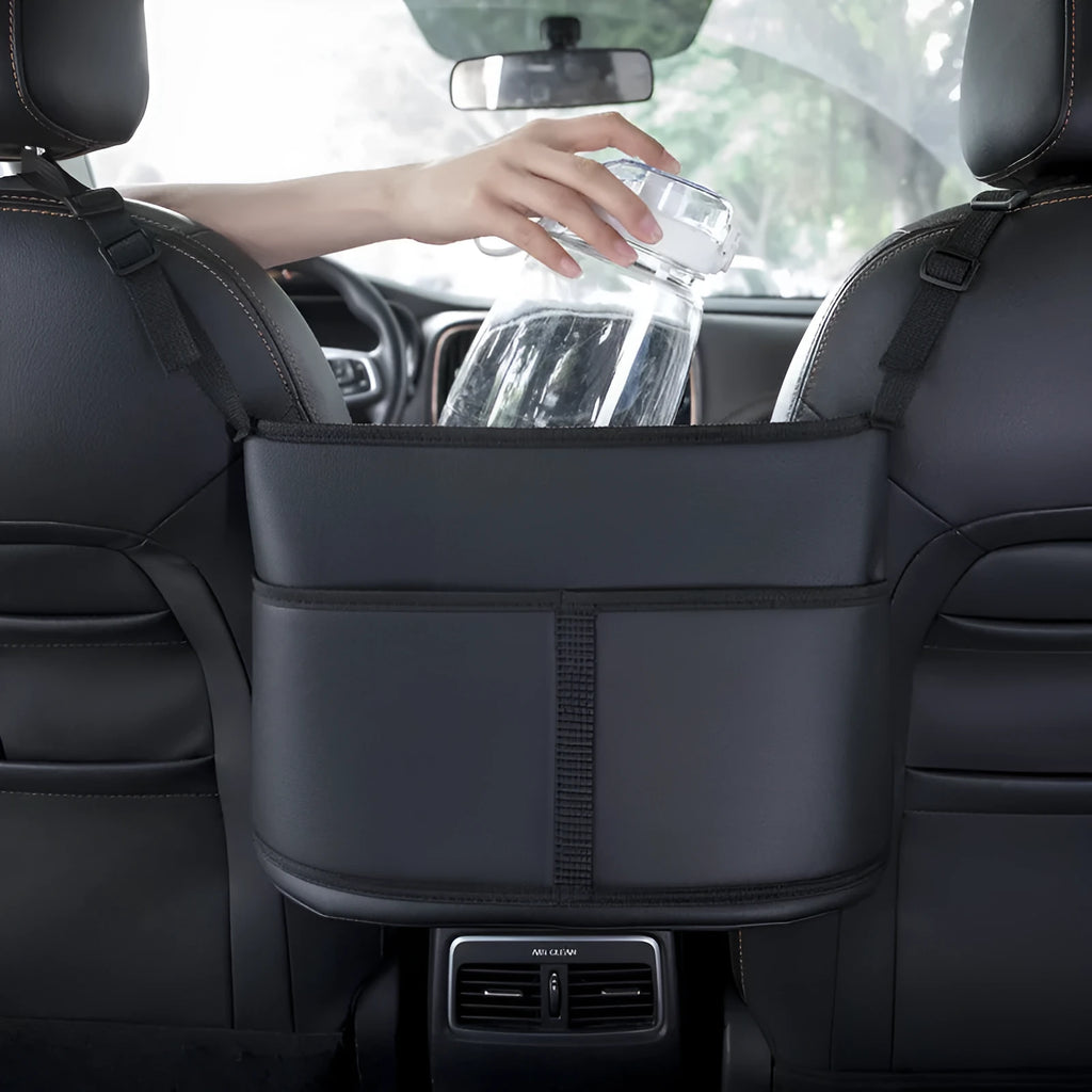 Black leather car seat storage bag with a carbon fibre pattern, showing its size next to a car seat.