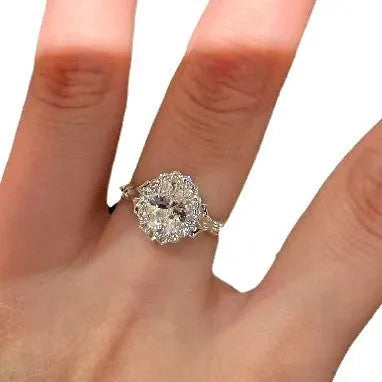 Silver-colour geometric ellipse women's ring with central diamond on an adjustable band.
