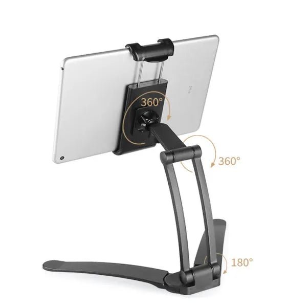 Silver aluminium alloy desktop tablet stand holding a tablet, showing its 360-degree rotation and adjustable chuck mechanism.