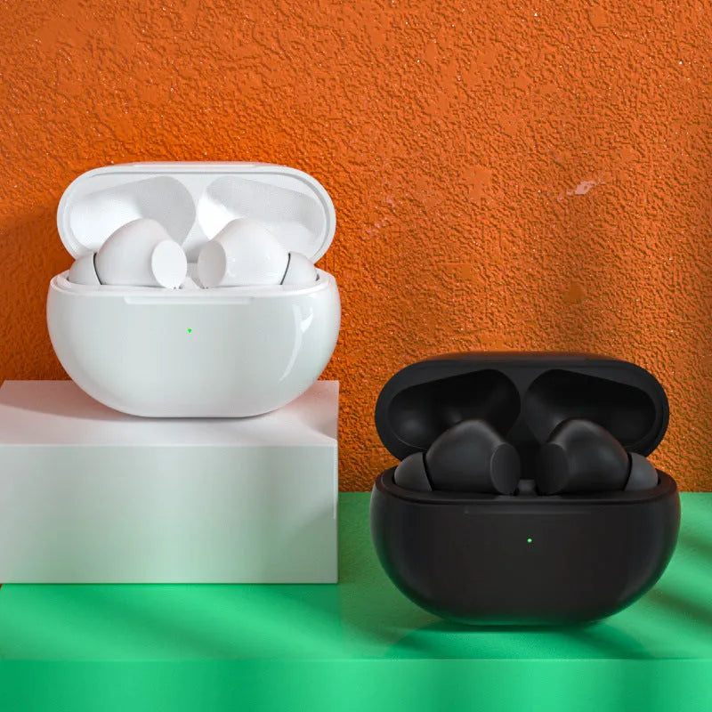 Black and white Pro4 true wireless Bluetooth earbuds with compact charging case on a table.