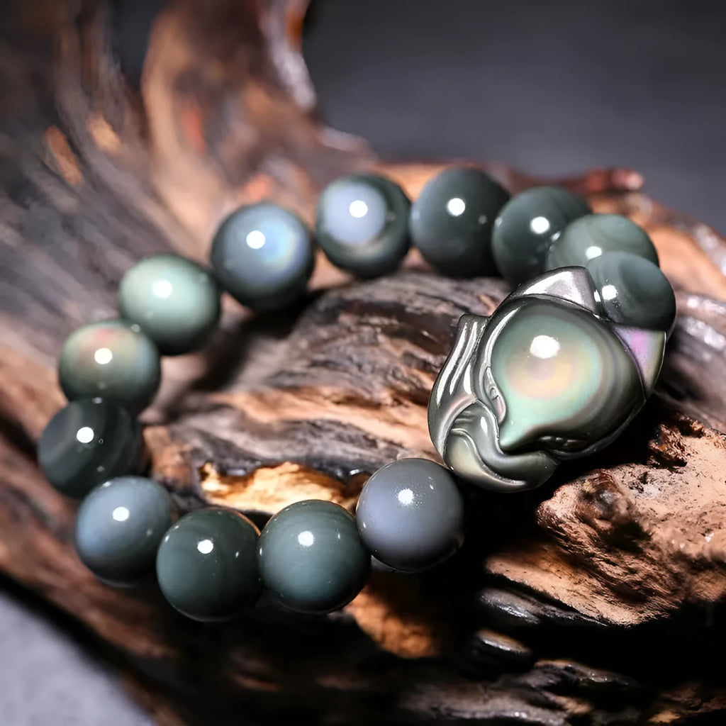 Obsidian stone bracelet with carved fox design in cartoon style, showing bead size options.