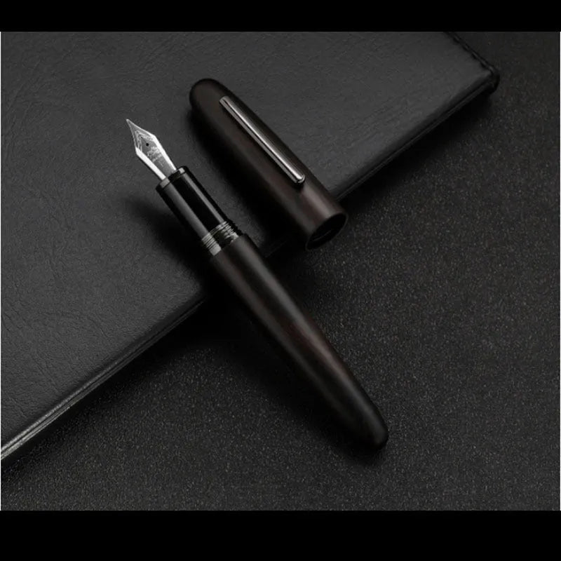 Wooden fountain pen with rotating cap showing grain detail and nib options