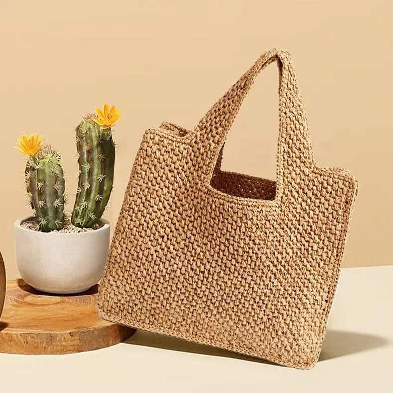 Straw woven bucket tote bag in khaki colour with double straps and open pocket.