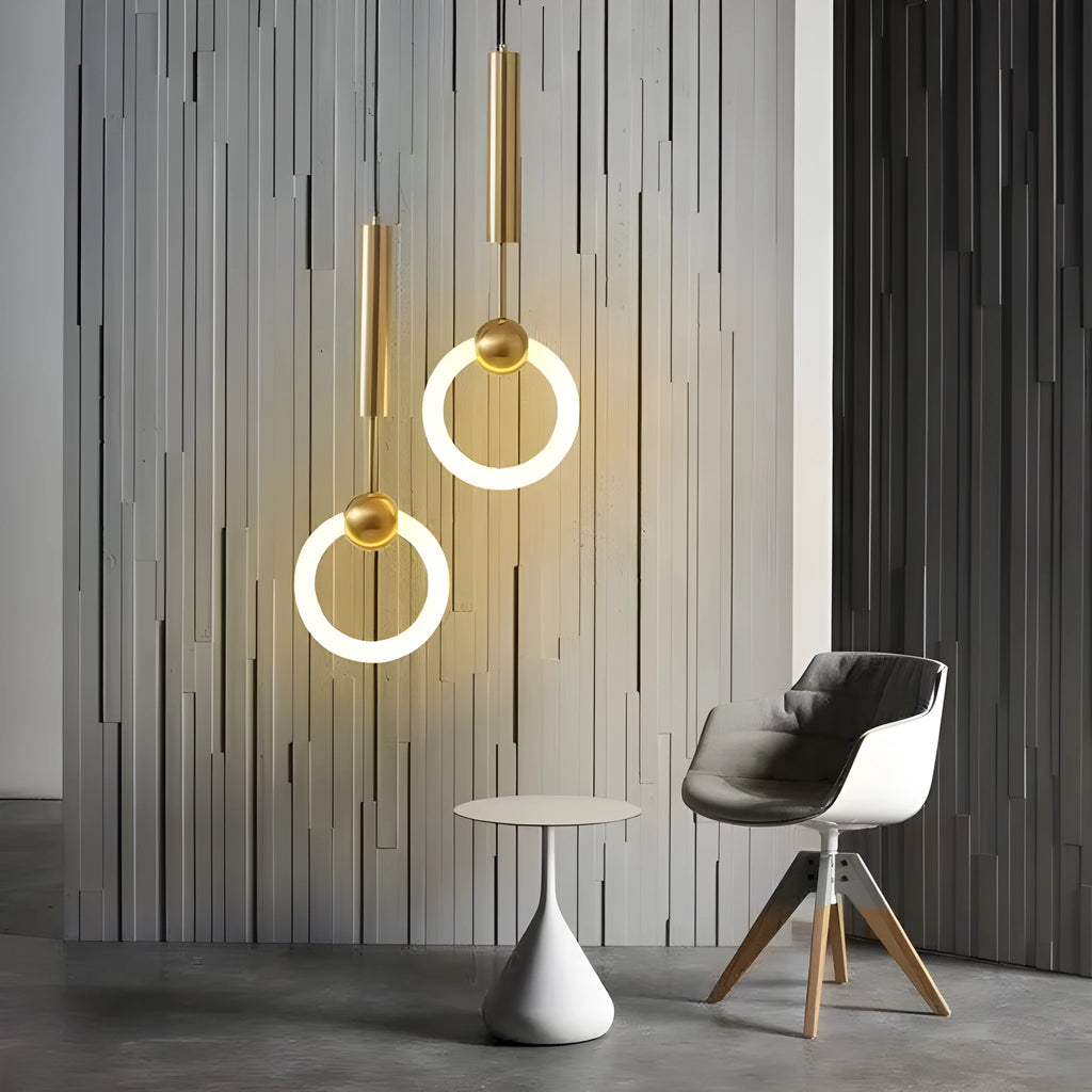 Minimalist black U-shaped pendant light with a downward-facing bulb mounted next to a bed.