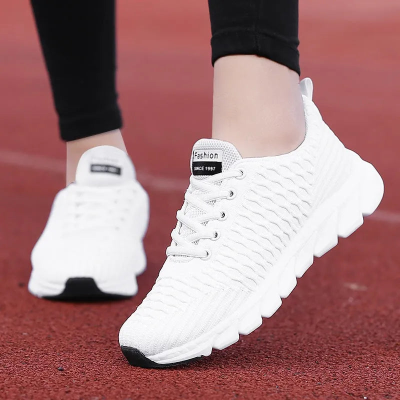 Women's running shoes in black, pink, or white with fly weave upper and wear-resistant outsole
