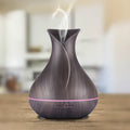 Ultrasonic aroma diffuser with 400ml capacity, dark wood finish, and 7 LED colour light display