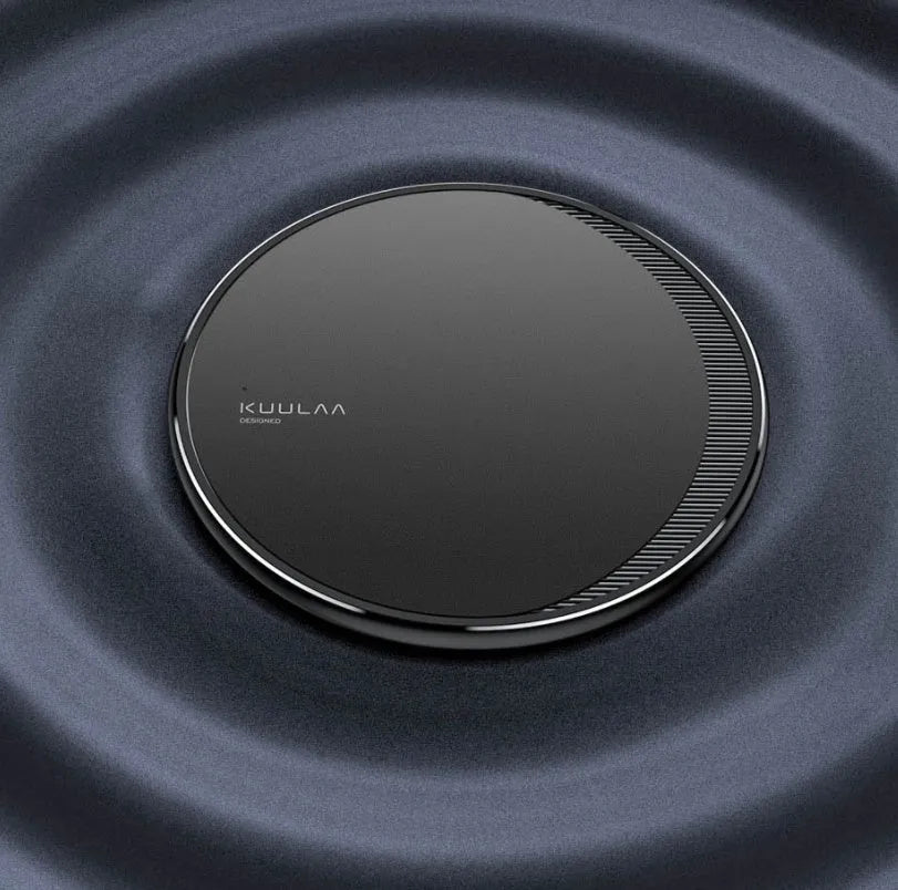 Black circular wireless disc charger for mobile phones with LED indicator light