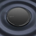 Black circular wireless disc charger for mobile phones with LED indicator light