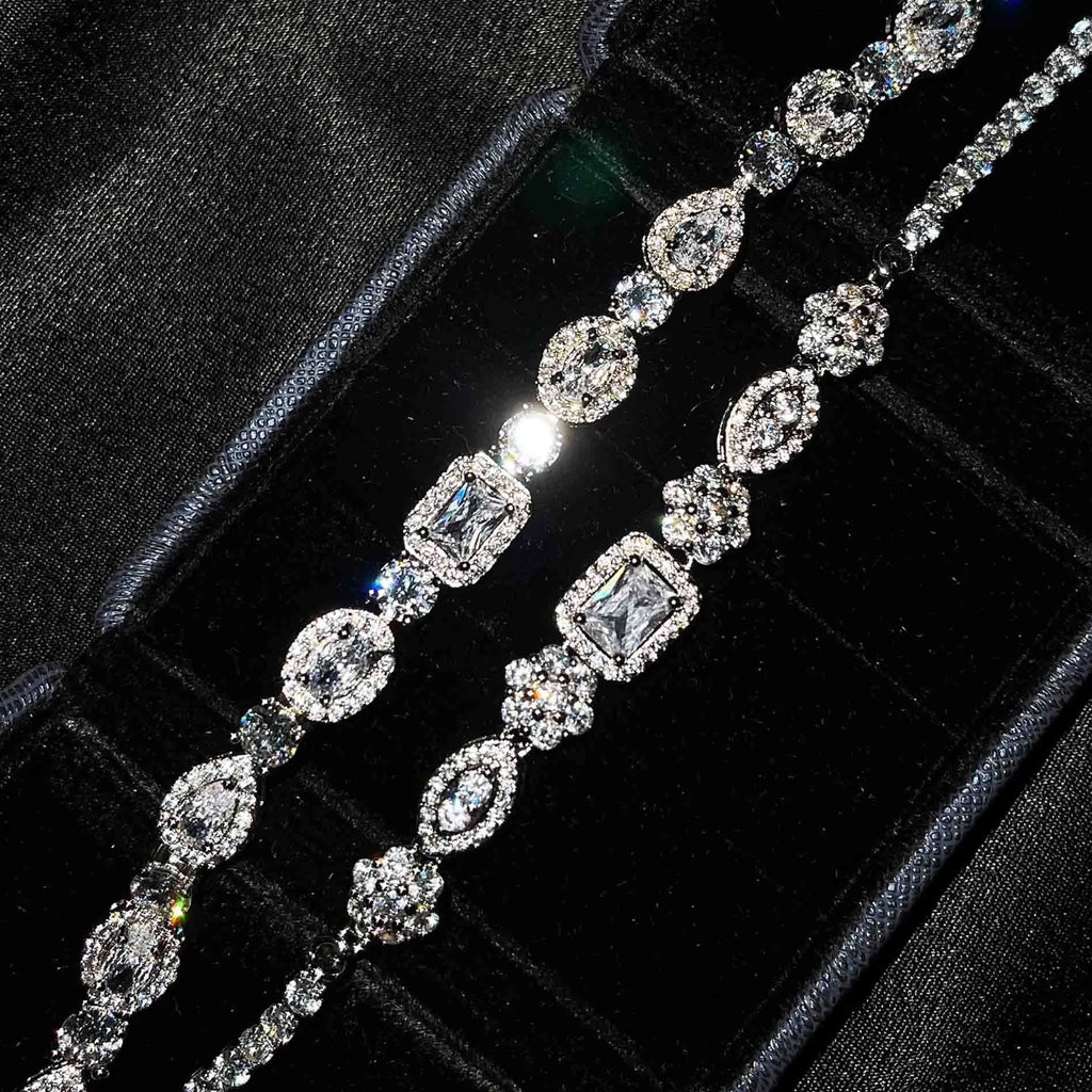 Women's geometric silver bracelet with adjustable chain and sparkling zircon stone on a wrist.