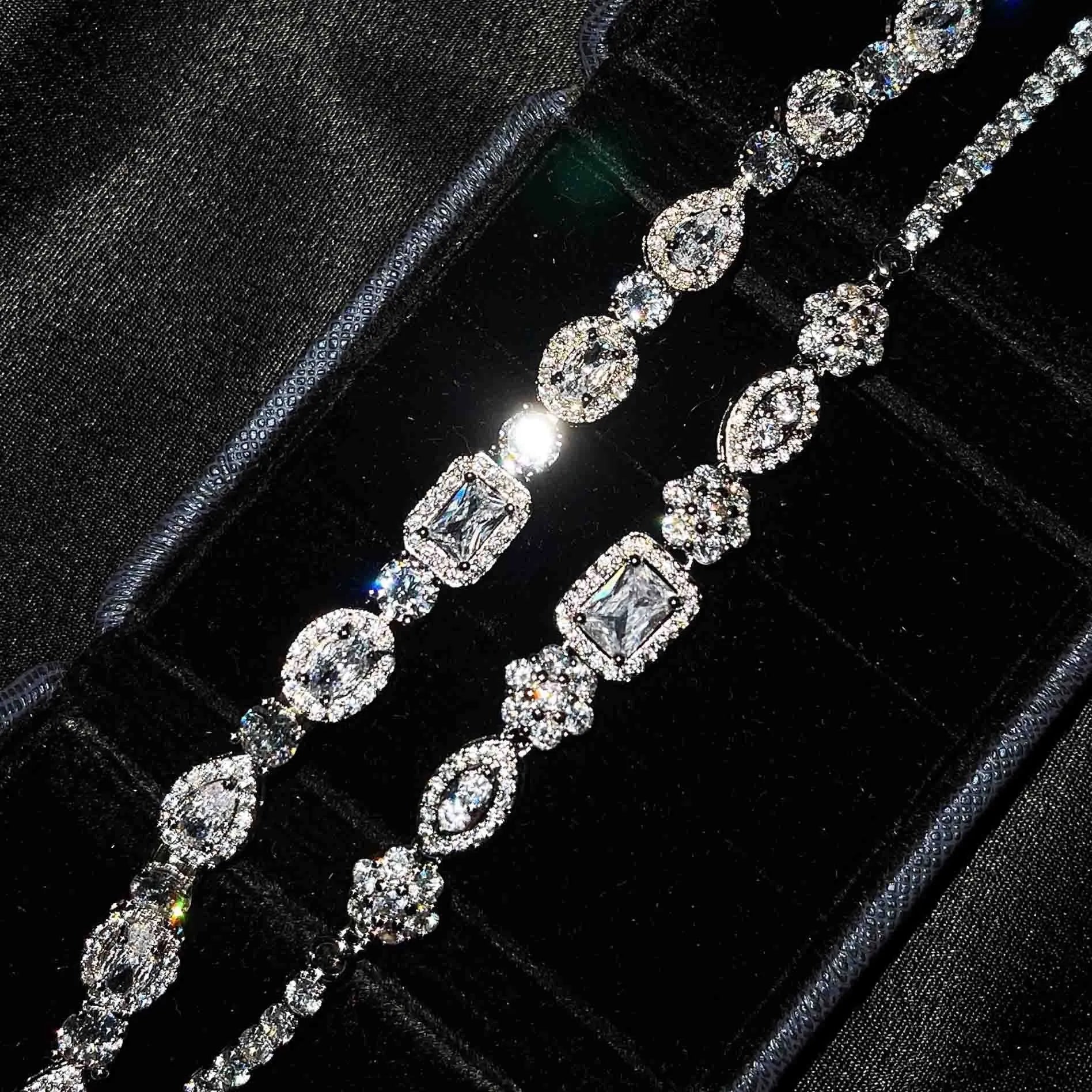 Women's geometric silver bracelet with adjustable chain and sparkling zircon stone on a wrist.