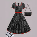 Multicolour polka dot dress with square neckline, short sleeves, front zip, and a pleated midi skirt.