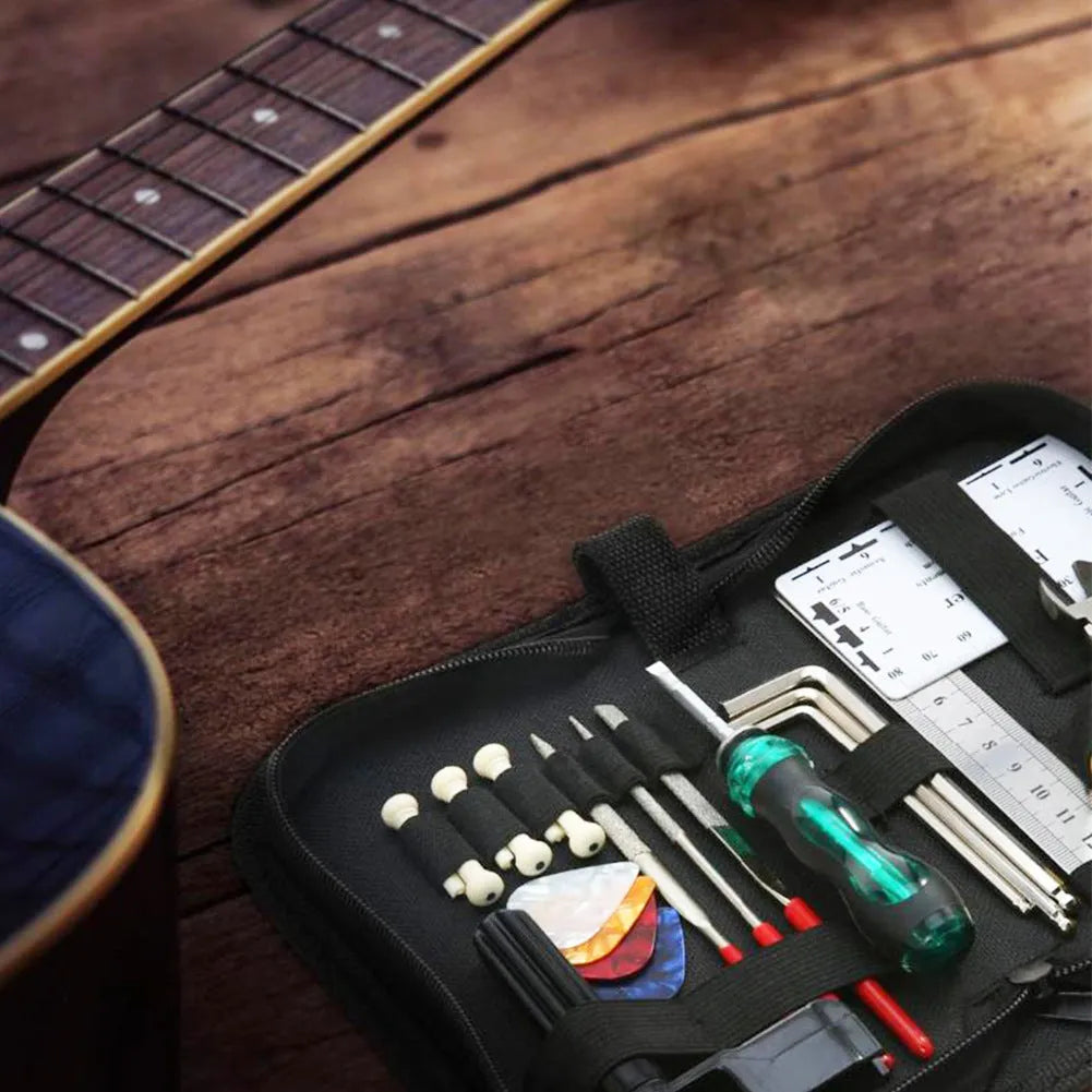 Black ABS plastic case open to reveal 11 metal guitar repair tools including a winder, cutter, ruler, and multi-tool.
