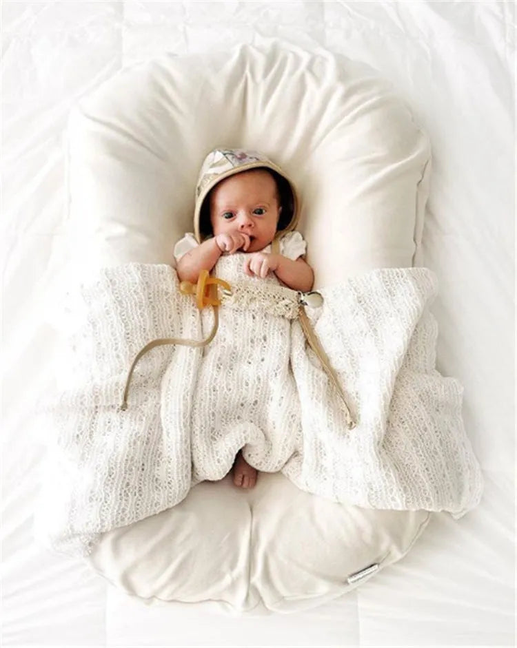 Portable baby nest crib in beige cotton measuring 45x75cm for infants