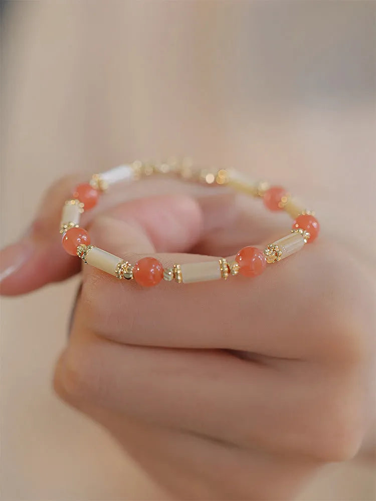 Women's green Hetian jade bracelet with a bamboo joint design.