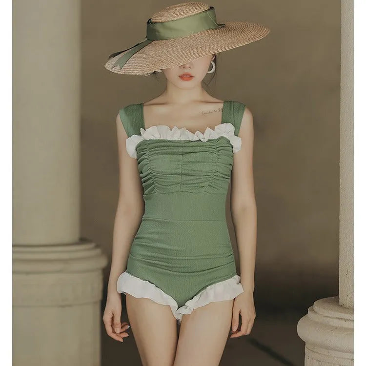 Black high-waisted one-piece swimsuit with triangle design on mannequin