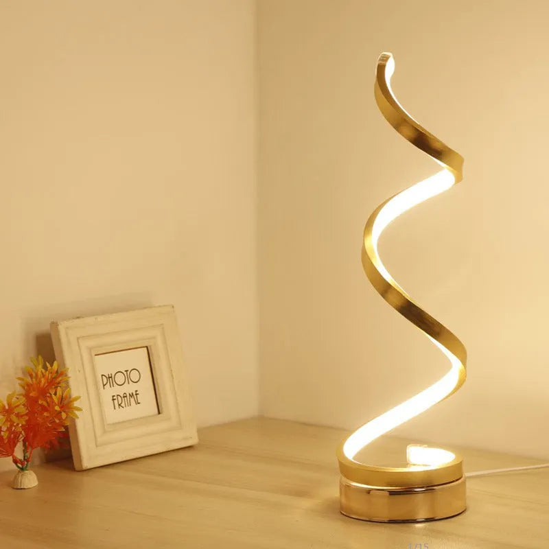 Minimalist black LED table lamp with aluminium shade on wooden desk